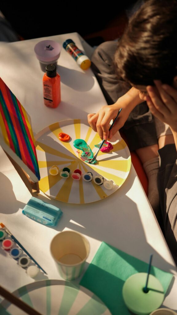 A child painting on a canvas in a sunny Gaziantep studio, surrounded by vibrant colors and art supplies.